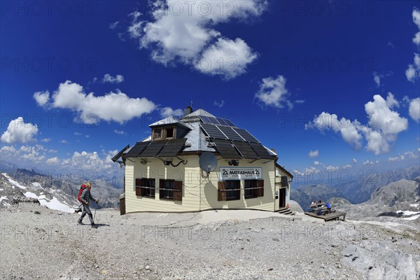 Mountaineer in front of the matras house