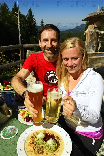 Hiker couple enjoying a snack on the Hindenburghutte