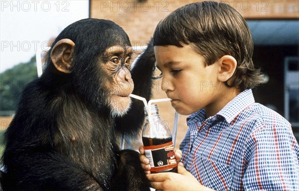 Monkey and boy share lemonade