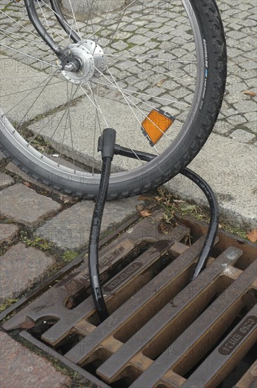Bicycle attached to the manhole