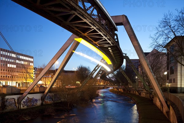 Trail of light from a moving suspension railway above the Wupper