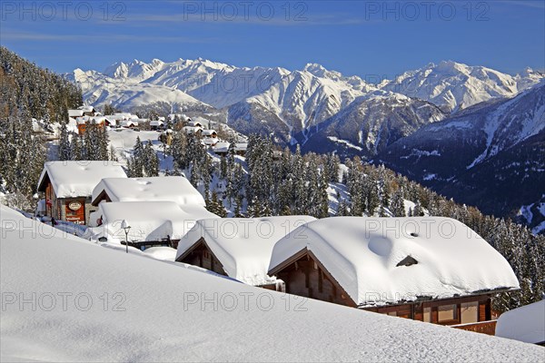 Winter landscape with snow-covered chalets