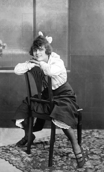 Woman sitting on a chair with her legs apart