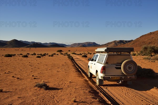 All-terrain vehicle drives on sandtrack