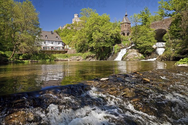 Pyrmonter mill at the waterfall of Elzbach with the castle Pyrmont in the back