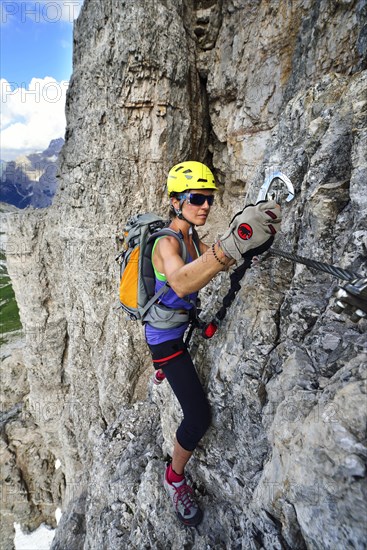 Female climber in the ladder at the Toblinger Knoten