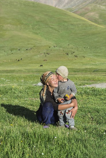 Kyrgyz boy kissing his mother