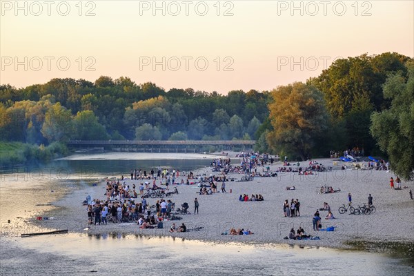 Young people on gravel bank at the riverbank