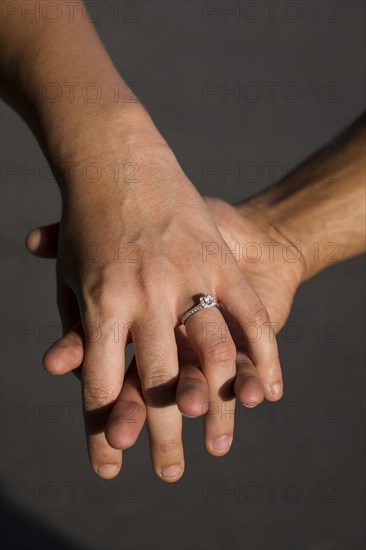 Engaged couple holding hands