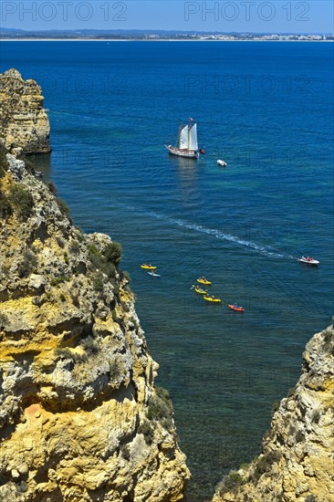 Sailing ship and sea kayaks off Camilo Beach
