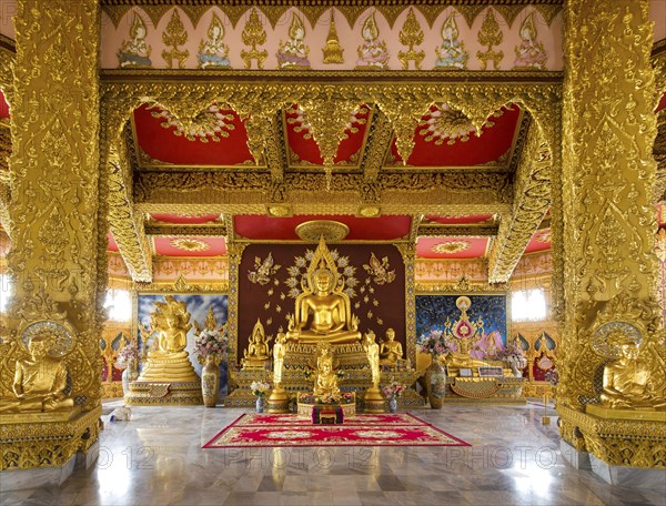 Gold plated Buddha statue in the altar of Phra Maha Chedi Chai Mongkhon Pagoda
