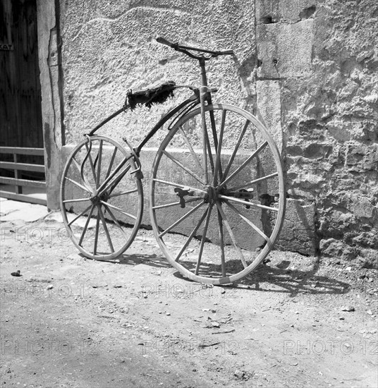 Pedal crank wheel leaning against a wall