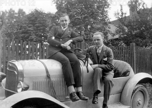 Two young men are proud of their car about 1929