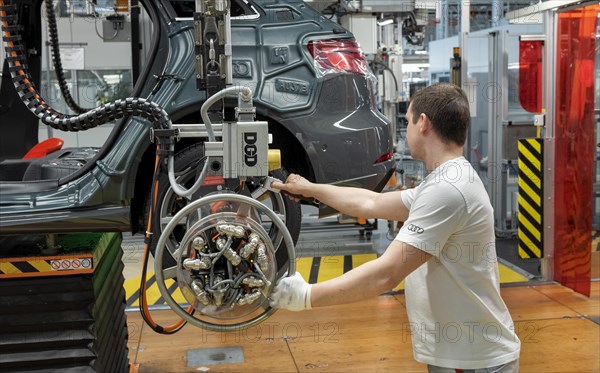 Installation of the wheels on the assembly line for Audi Q2 at the Audi AG plant in Ingolstadt