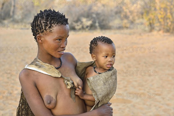 San woman with toddler in her arms