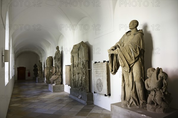 Arcades with artwork in the courtyard of the Asam church