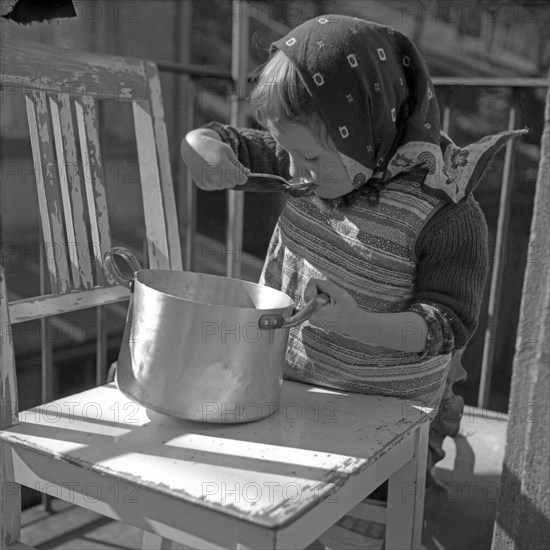 Child slurps out of a pot