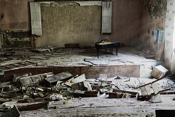 Stage with concert grand piano in destroyed building