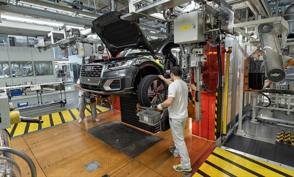 Installation of the wheels on the assembly line for Audi Q2 at the Audi AG plant in Ingolstadt