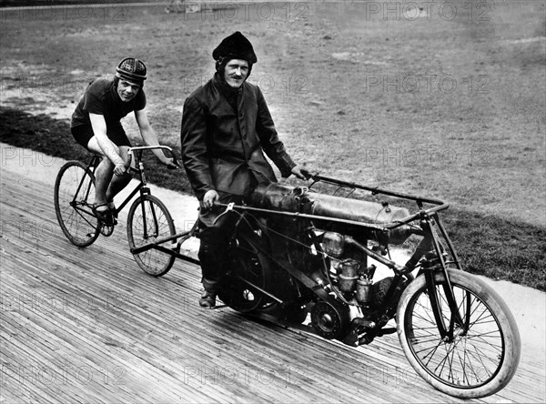 Bicycle rider in tow of a motorcyclist