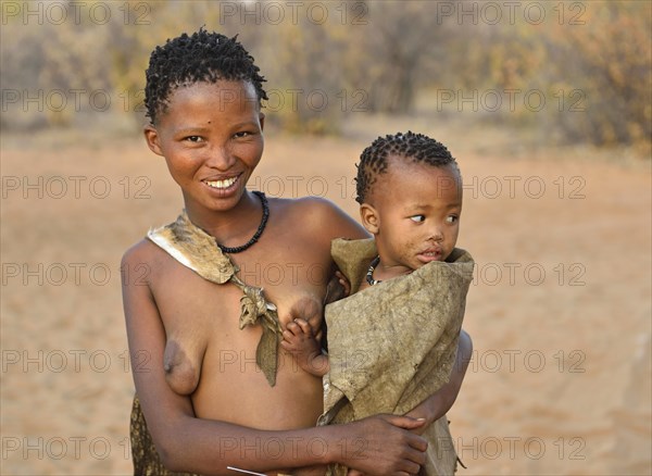 San woman with toddler in her arms