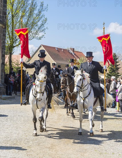 Sorbian men riding on decorated horses