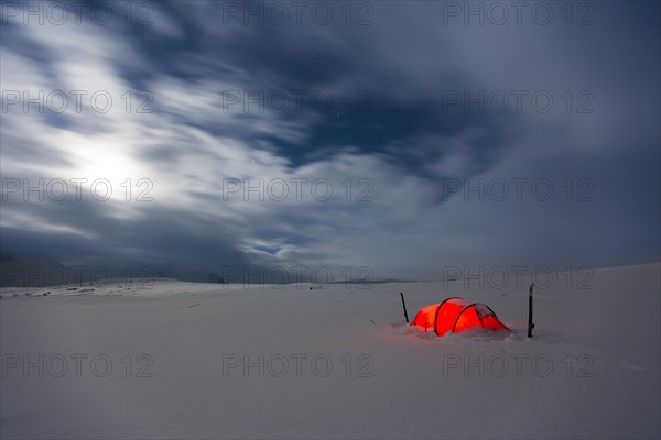 Tent by full moon in the snow