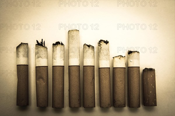 Alignment of nine cigarette butts