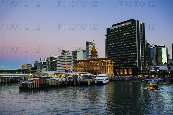 Illuminated waterfront with Ferry Building during dusk