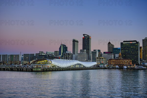 Illuminated waterfront with The Cloud during dusk