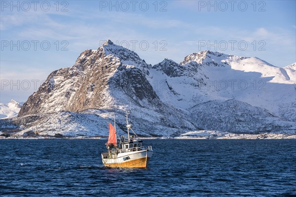 Traditional fishing boat catching the net