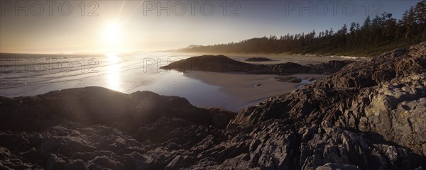 Sunset scenery of the sandy Long Beach. Pacific ocean shore at Green Point