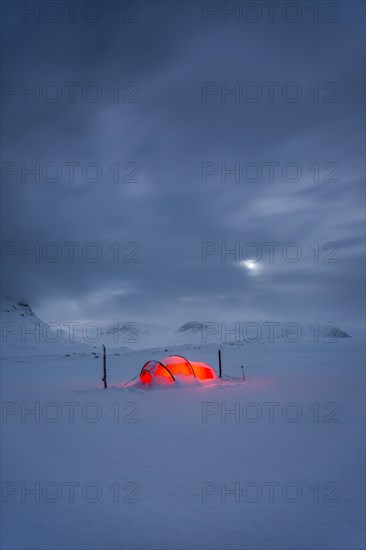 Tent by full moon in the snow