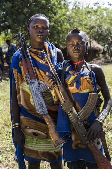 Two young women with Kalashnikovs