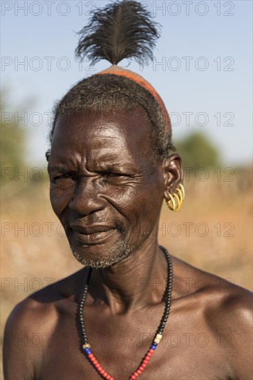 Elderly man with hair ornaments