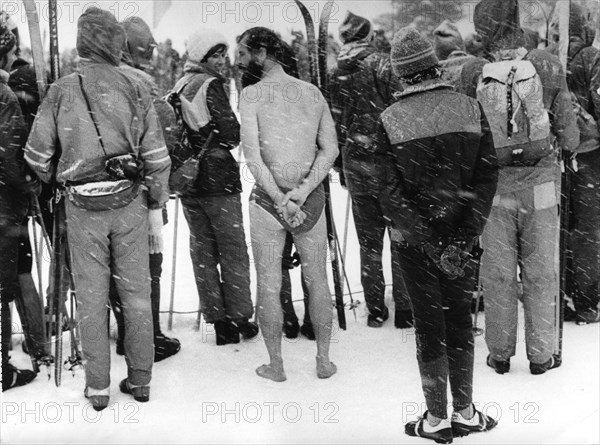 Naked man between skiers ca. 1970s