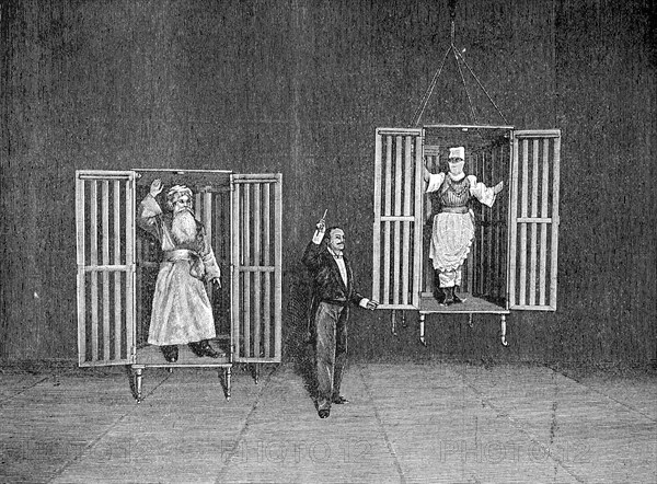 The illusionist Thorn demonstrates the appearance and disappearance of persons in cages