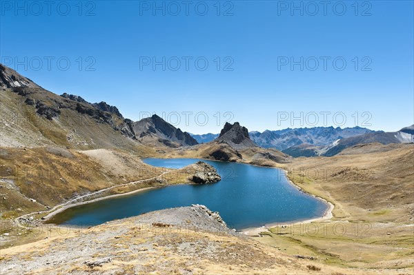 Barren mountain landscape with lake Lago superiore di Roburent