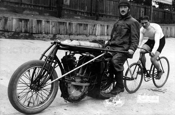 Bicycle rider in tow of a motorcyclist