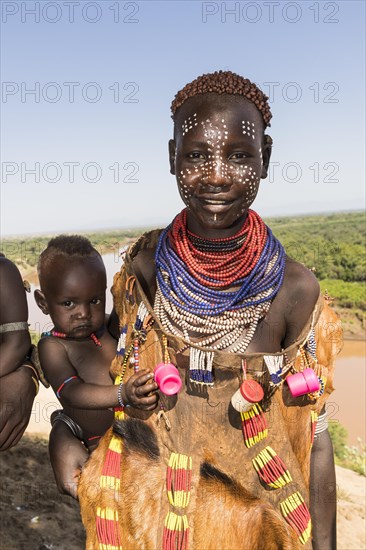 Young women with face painting and baby