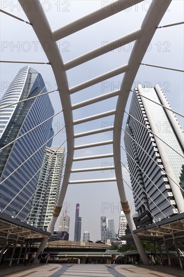 High-rise buildings in the business district Sathon and pedestrian bridge to BTS Skytrain station Chong Nonsi