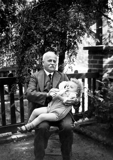 Grandpa gives bottles ca. 1926