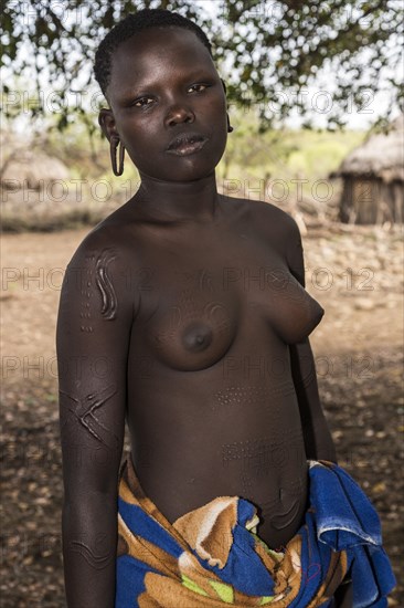 Young woman with ornamental scars on her body