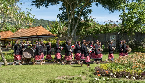 Procession of devout Buddhists with Gamealan musicians at the water temple Pura Ulun Danu Bratan