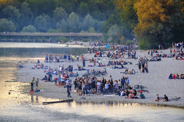 Young people on gravel bank at the riverbank