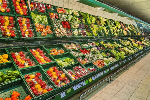 Shelf with packed vegetables in supermarket