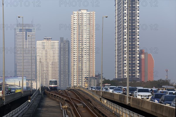 BTS Skytrain drives next to a motorcade