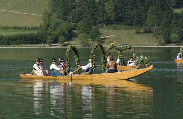 Men wearing traditional costumes in festively decorated squares