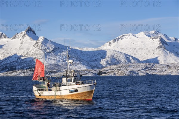 Traditional fishing boat catching the net