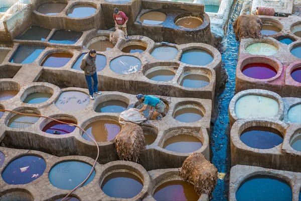 Worker dyeing leather